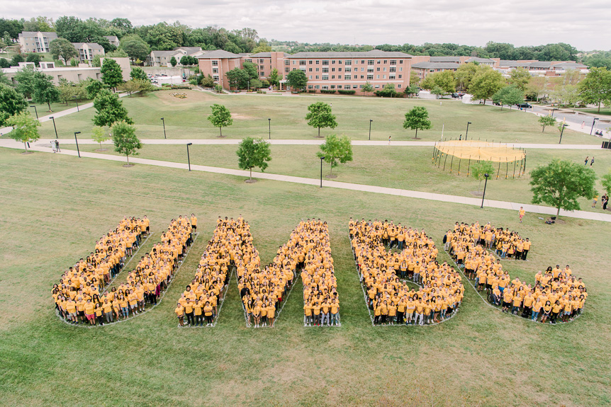 Sample image - Students stand together to form the letters UMBC from above