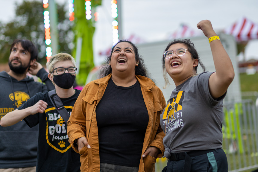 Sample image - students smile while enjoying the UMBC Homecoming Carnival